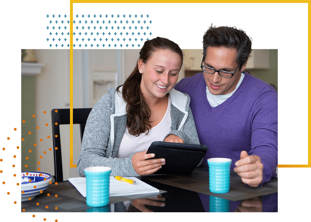 Father and teenage daughter reading